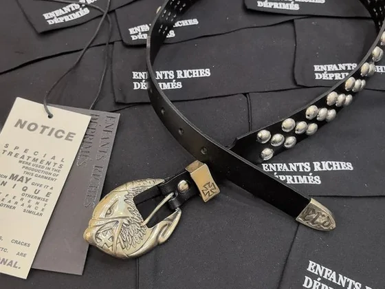 Black studded belt with a metal buckle